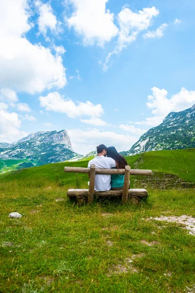 depositphotos_213241504-stock-photo-rear-view-couple-sitting-wooden